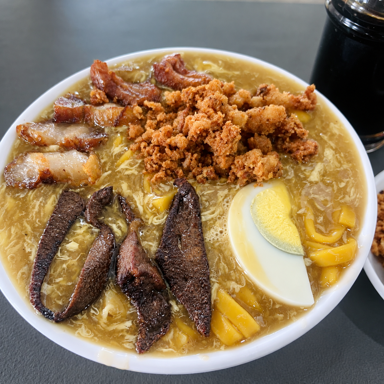 A steaming bowl of lomi